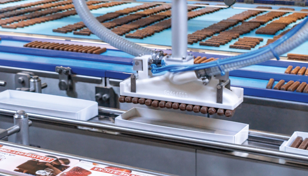 A Schubert F4 robot places Sweet Candy Company chocolate bars filled with different fruit gelatin in a box